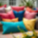 A vibrant collection of Sunbrella pillows arranged in an outdoor setting showcasing their colors.