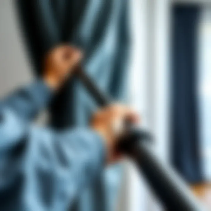 Thick black curtain rod installation demonstration in progress