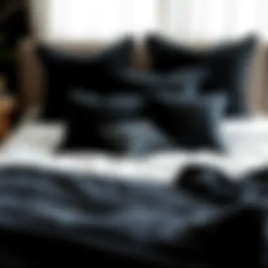 Creative arrangement of soft black throw pillows on a bed