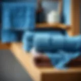 Elegant display of blue bath towels folded neatly on a wooden shelf